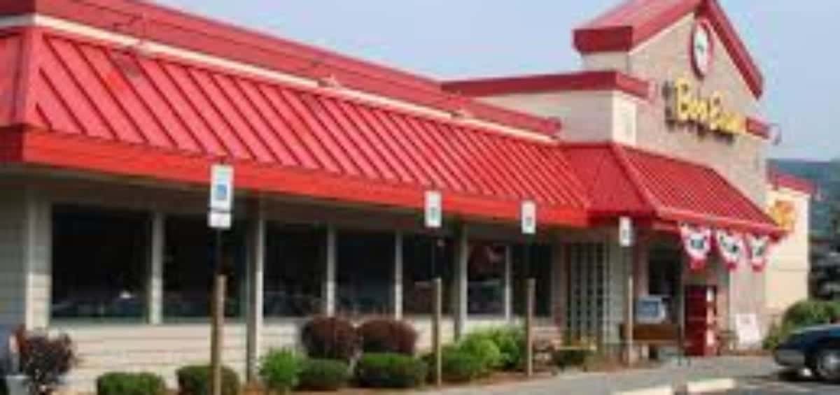 A single-story restaurant with a red roof, many windows, and a visible entrance. It has a parking lot with accessible parking spots in front.