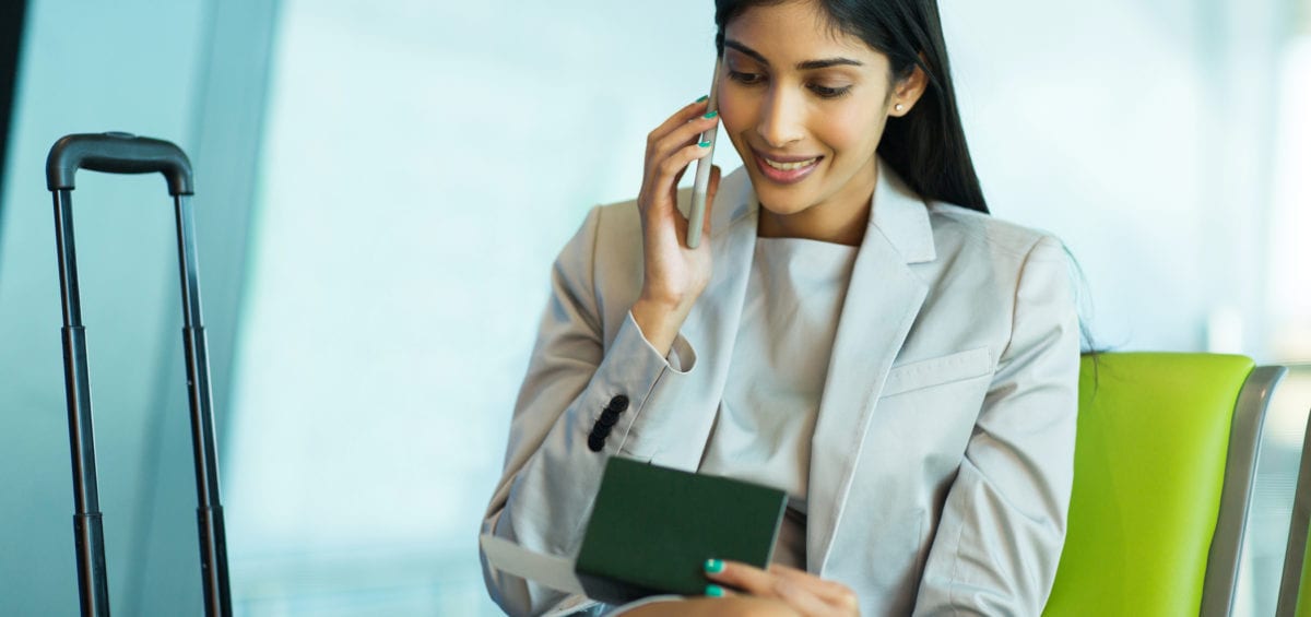 business woman talking on mobile phone in airport