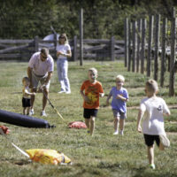 0008_ARG_Fall25 A group of kids running on grass.