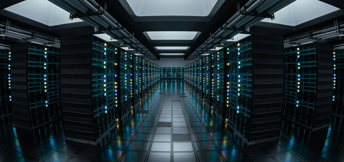 A modern data center with rows of illuminated server racks, reflective flooring, and overhead lighting.